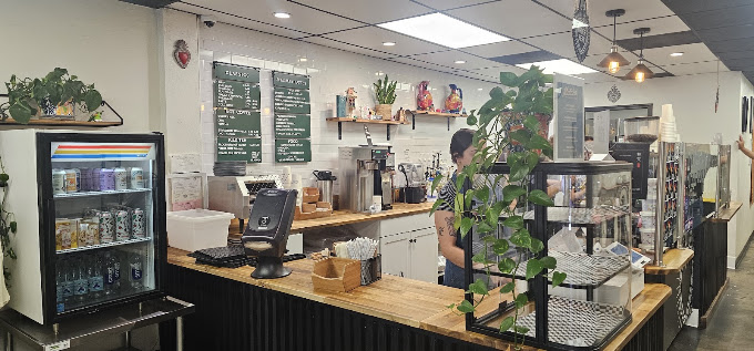 Inside Corazón Coffee Bar — the counter, espresso machine, and pastry case